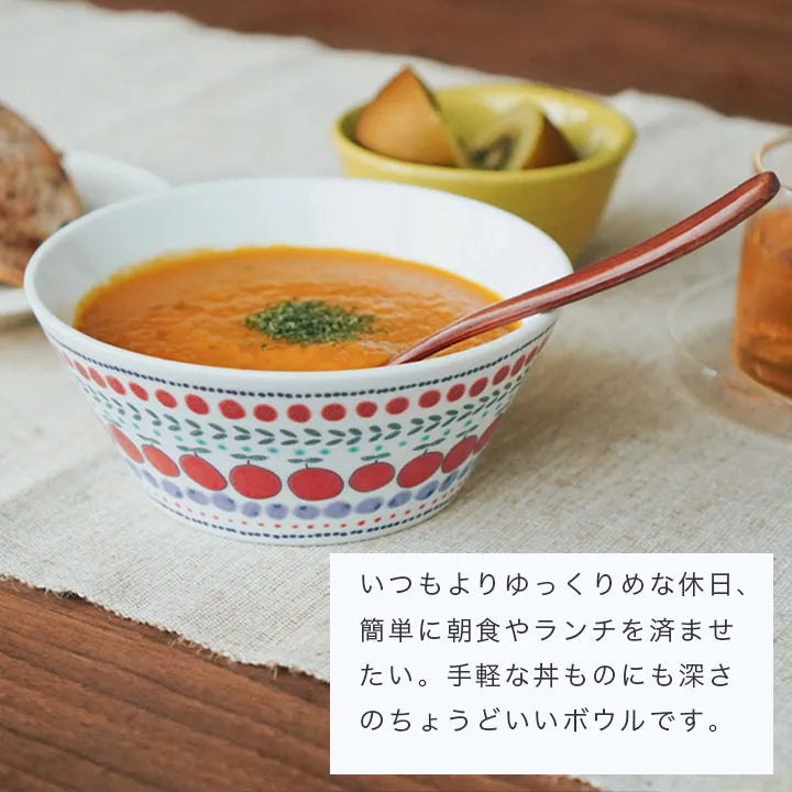 Bowl of soup with a spoon on a wooden table