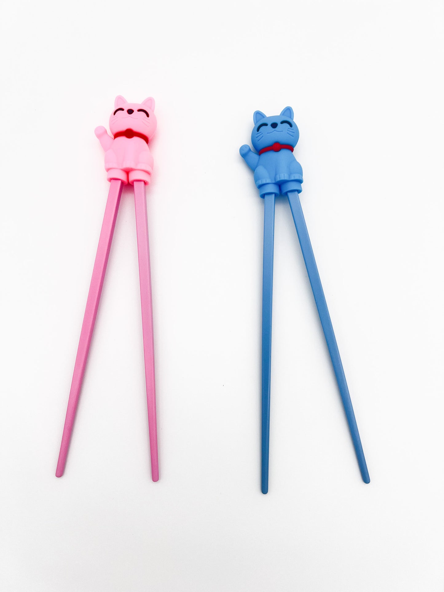 Pink and blue cat-shaped chopsticks on a white background