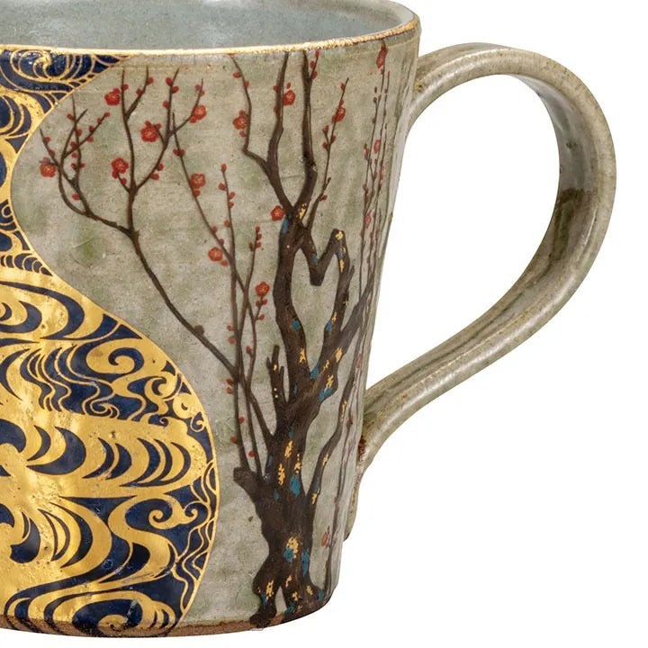 Ceramic mug with artistic design of tree branches and abstract patterns on a greyish green background