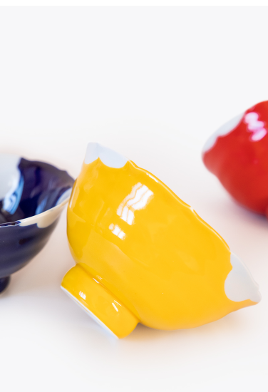 Yellow ceramic bowl with a white interior on a white background. Japanese Ceramics. Made in Japan.