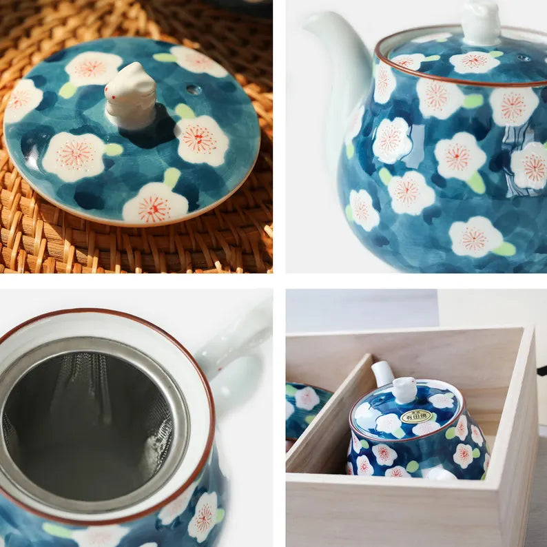 Set of ceramic teaware with floral design on a wooden surface and in a drawer.
