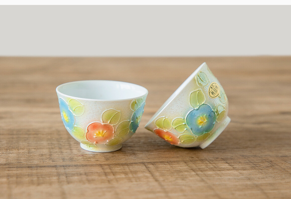 Ceramic cup with floral design on a wooden surface