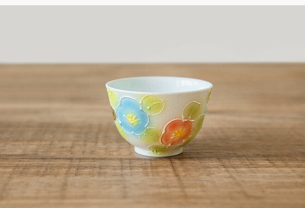 Ceramic cup with floral design on a wooden surface
