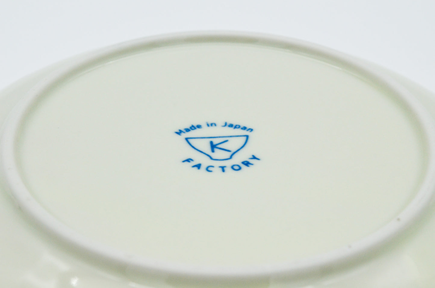 White plate with 'K Factory' logo and 'Made in Japan' text on a white background