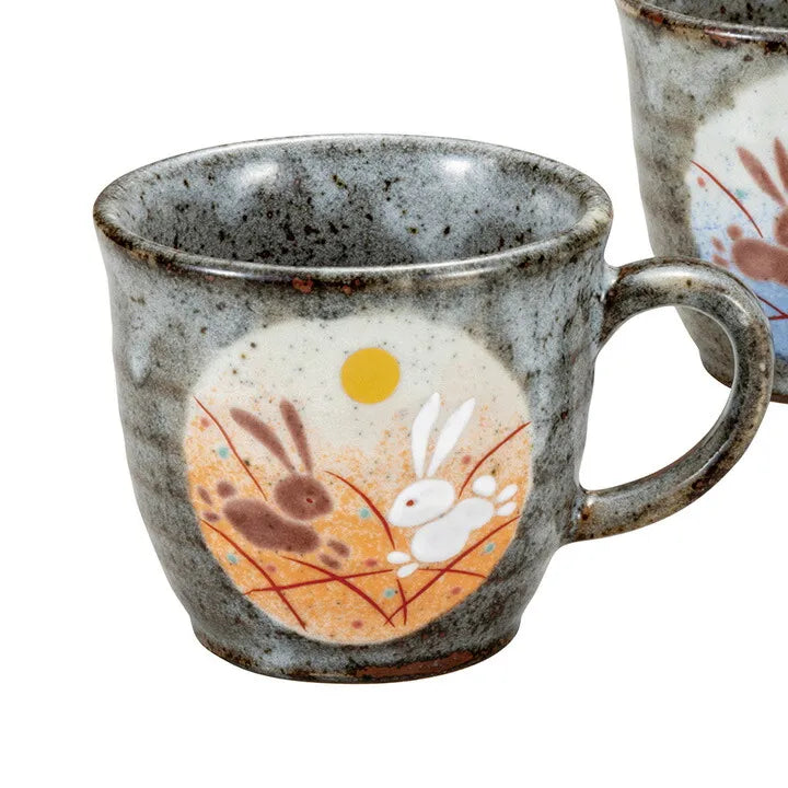 Ceramic mug with rabbit and full moon design on a white background