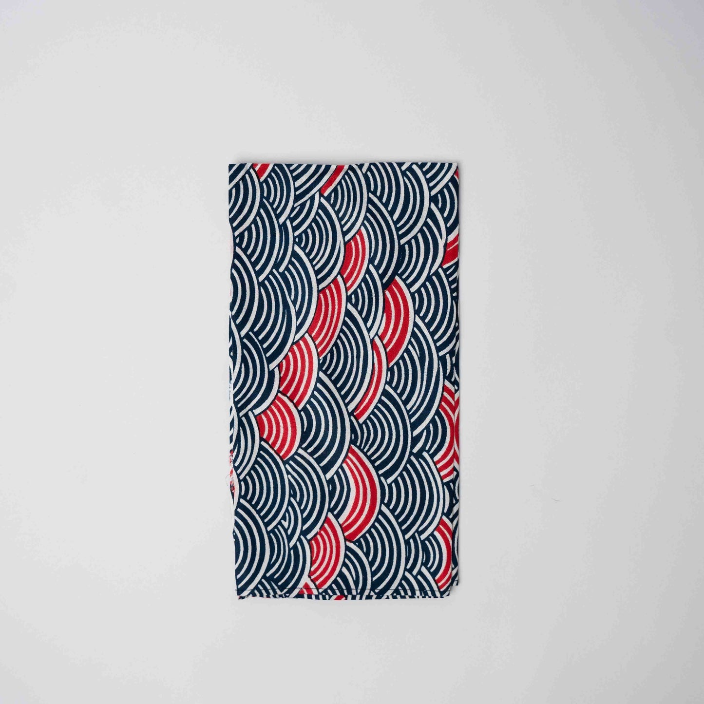Fabric with red and blue wave pattern on a white background
