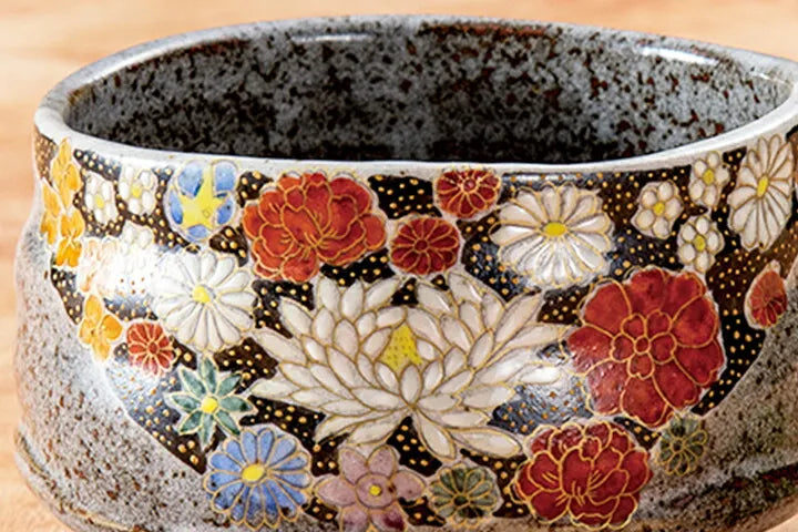 Decorative ceramic bowl with floral patterns on a wooden surface