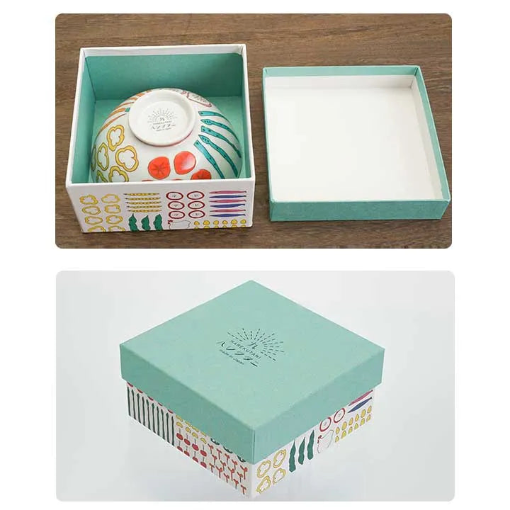 Decorative box with a ceramic item inside on a wooden surface