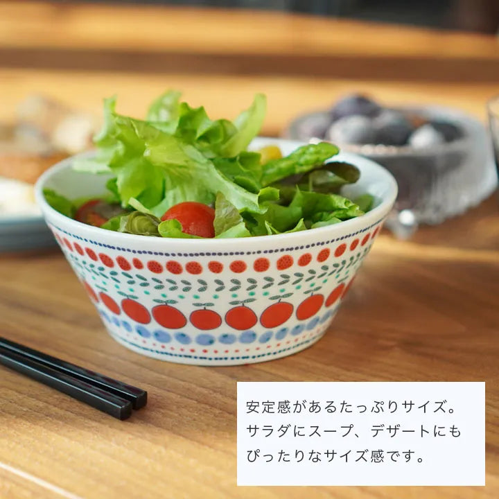 Bowl with salad on a wooden table