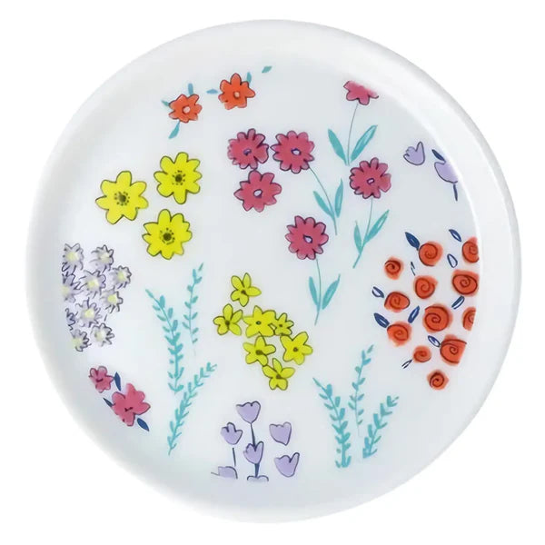 Round white plate with colorful floral pattern on a white background