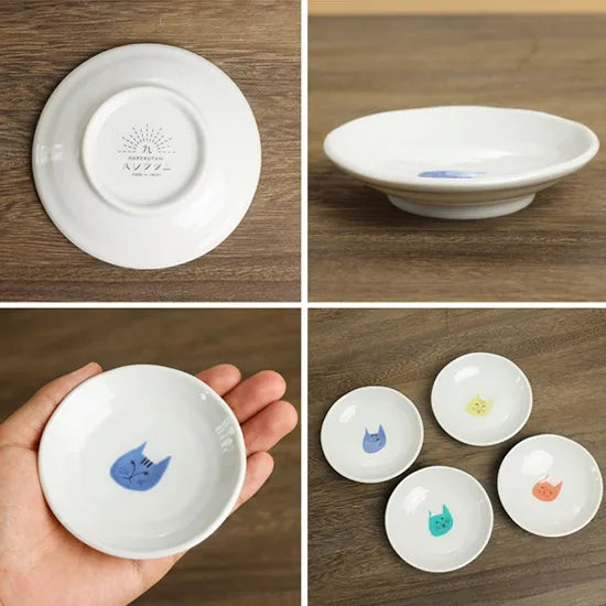 Set of small white ceramic dishes with various designs on a wooden surface