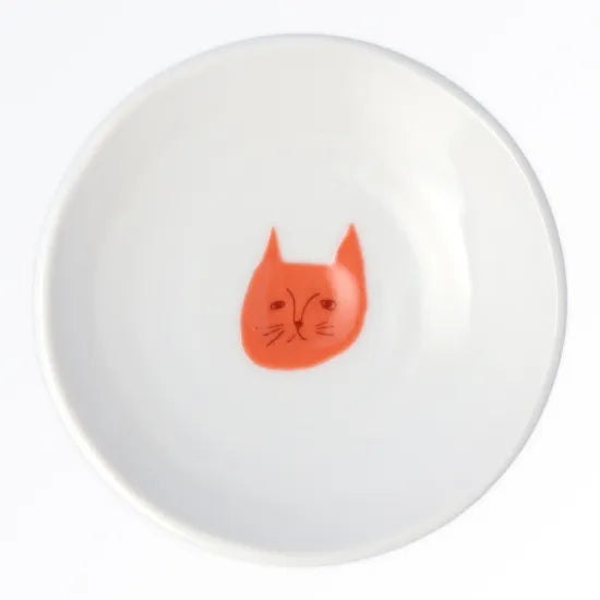 White plate with a red cat face design on a white background