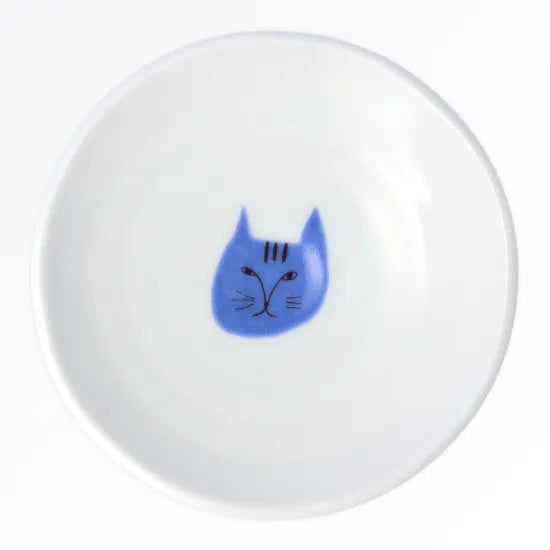 White round plate with a blue cat face design on a white background