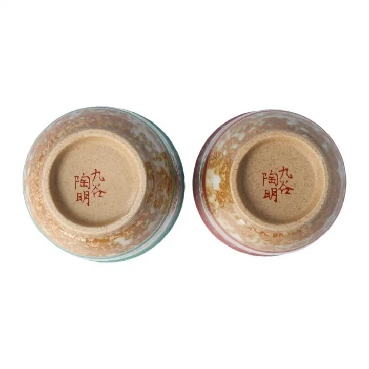 Two ceramic tea cups with Japanese inscriptions on a white background