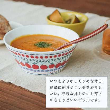 Bowl of soup with a spoon on a wooden table