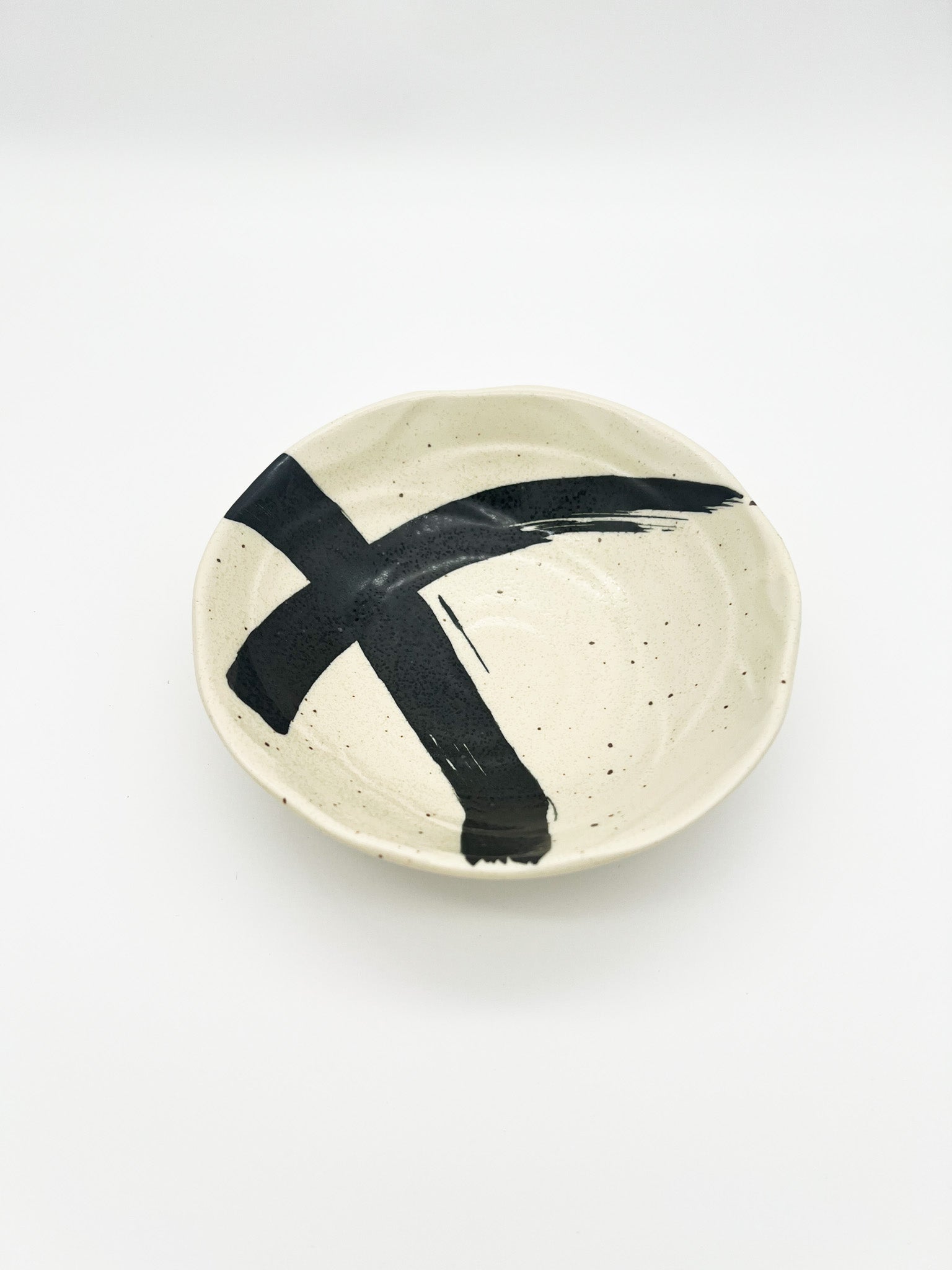 Ceramic plate with black abstract design on a white background