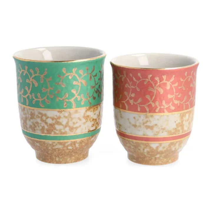 Two ceramic mugs with decorative gold patterns on a white background