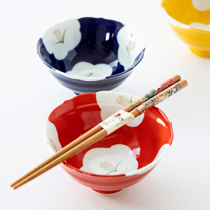 Two ceramic bowls with floral designs, one red and one blue, on a white background. Japanese Ceramics. Made in Japan.
