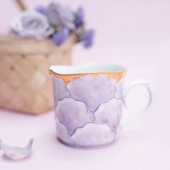 Ceramic mug with cloud design on a light background