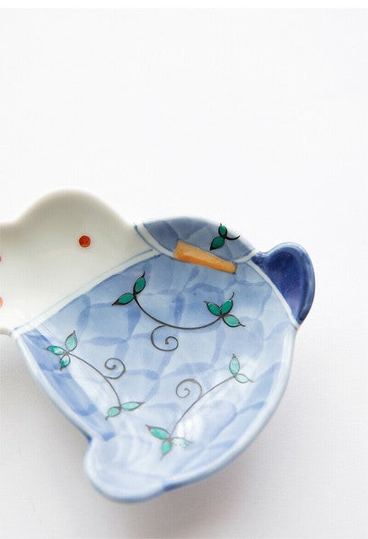 Ceramic cat-shaped dish with a blue dress design on a white background