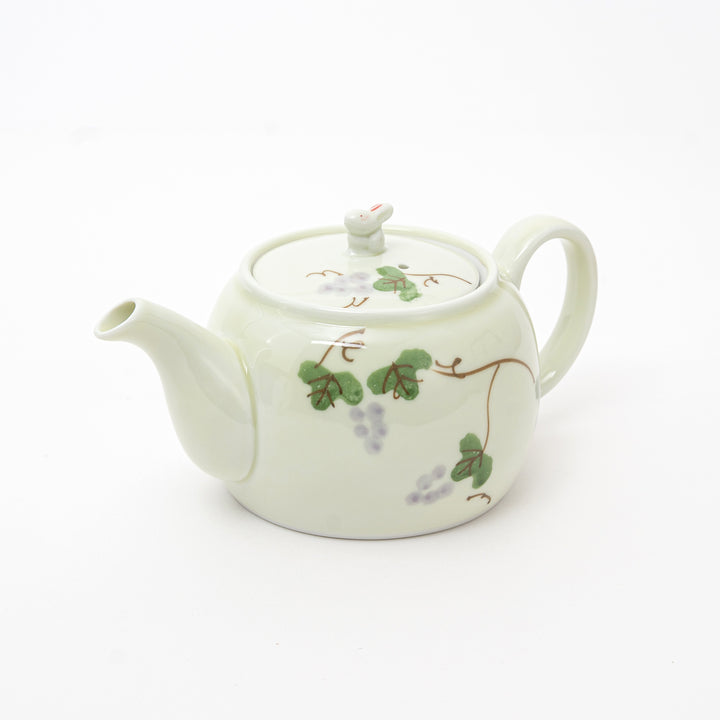 White teapot with floral design on a white background