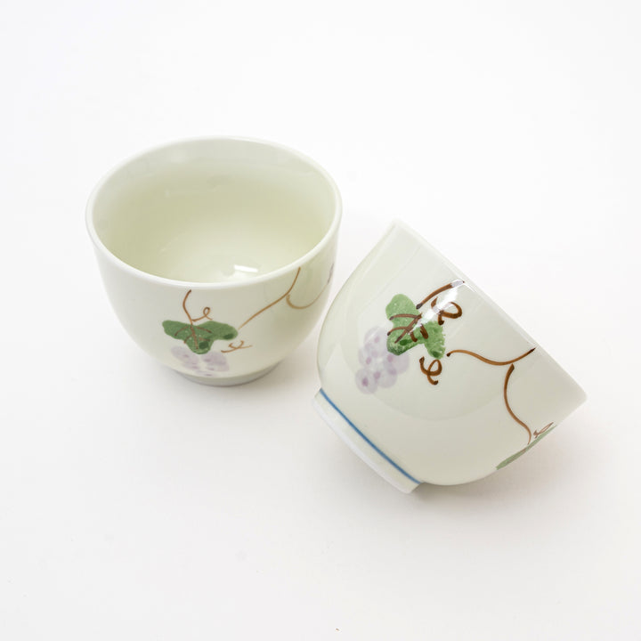 Two ceramic cups with floral designs on a white background