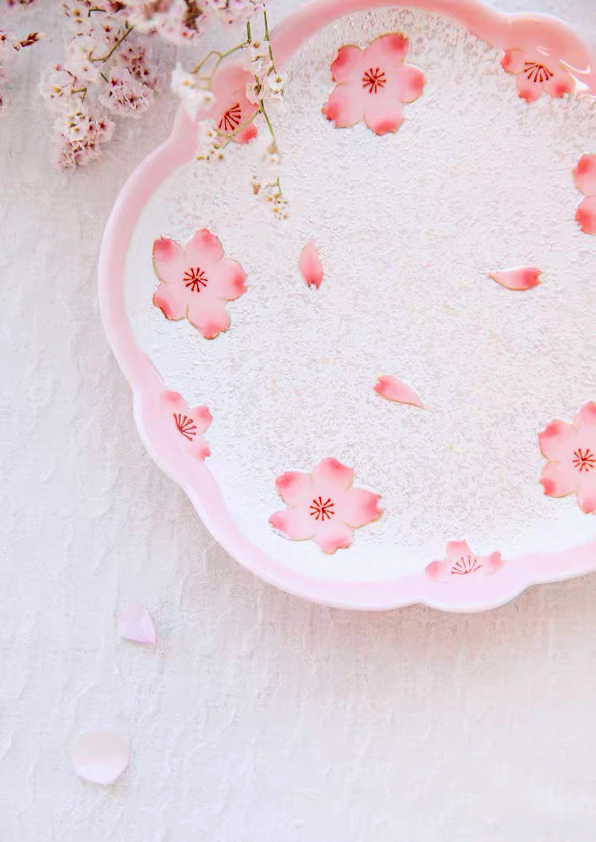 Decorative plate with pink floral patterns on a light background