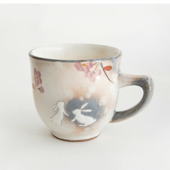Ceramic mug with floral and animal design on a white background. Japanese Ceramics. Made in Japan.