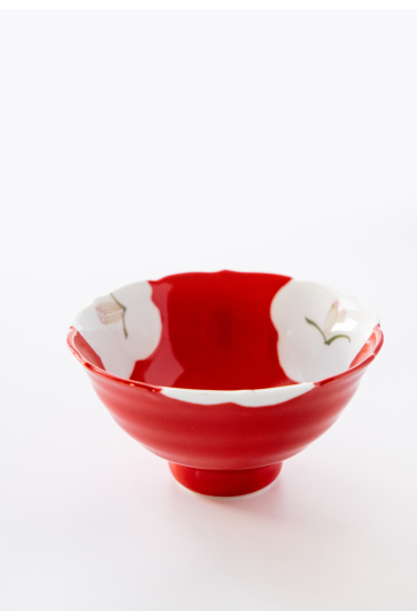 Red ceramic bowl with white interior and floral patterns on a white. background. Japanese Ceramics. Made in Japan.