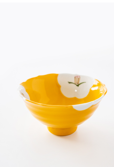 Yellow bowl with floral design on a white background. Japanese Ceramics. Made in Japan.