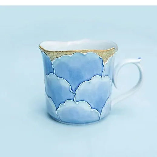 Made in Japan Ceramic mug with cloud design on a light blue background 