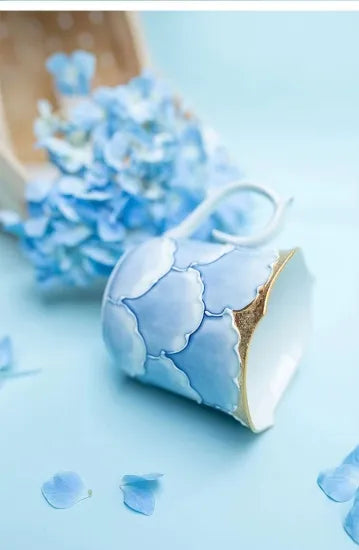 Blue ceramic container with gold accents on a light blue background