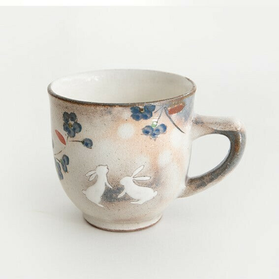 Ceramic mug with rabbit and floral design on a white background. Japanese Ceramics. Made in Japan.