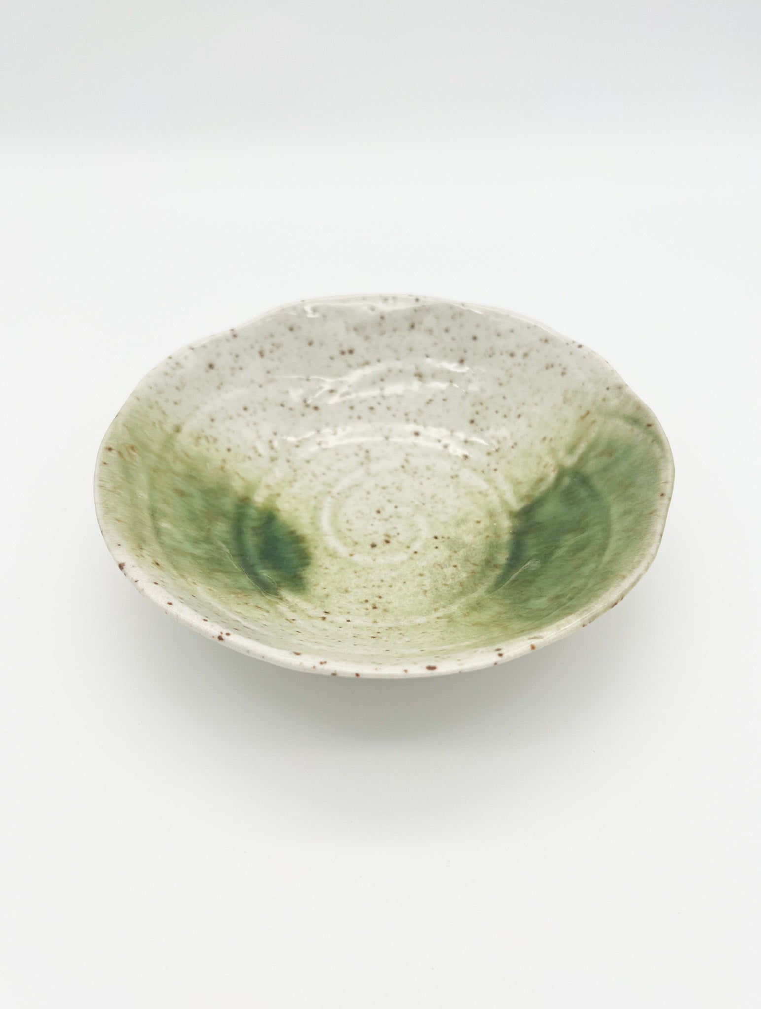 Green ceramic bowl on a white background