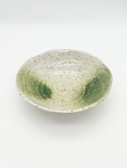 Green ceramic bowl on a white background