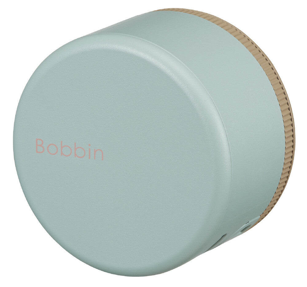 Light blue bobbin with wooden top on a white background