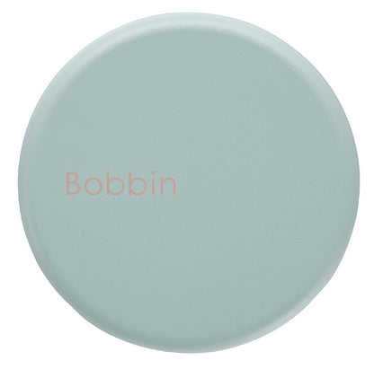 Round light blue object with 'Bobbin' text on a white background
