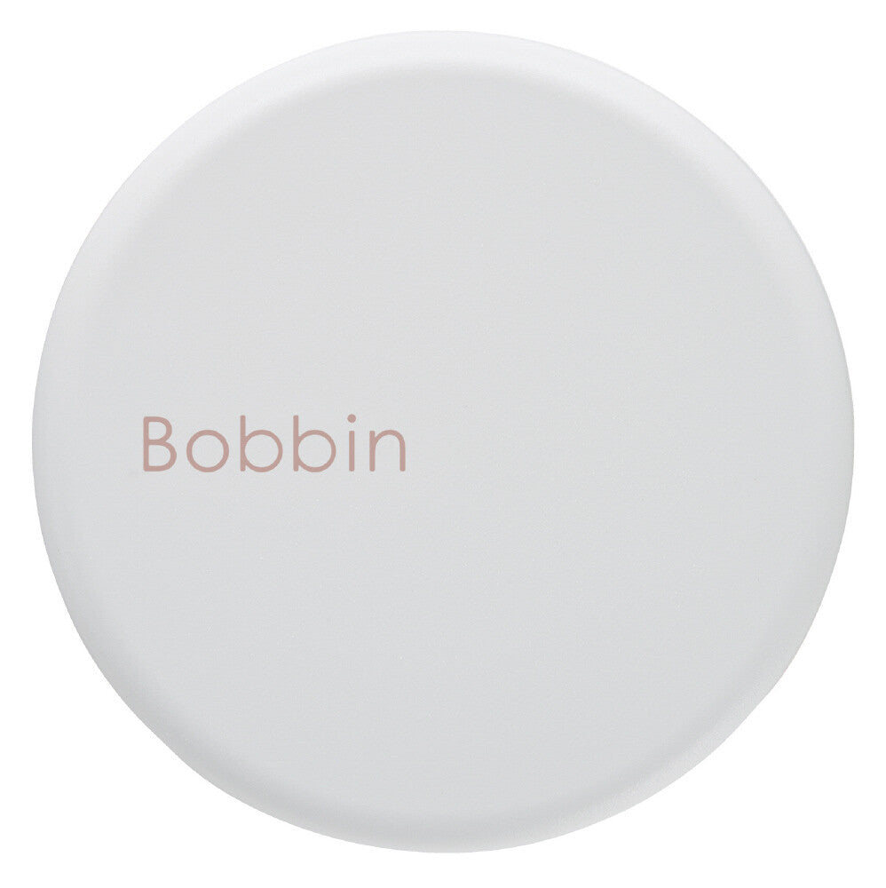 Round white object with 'Bobbin' text on a white background