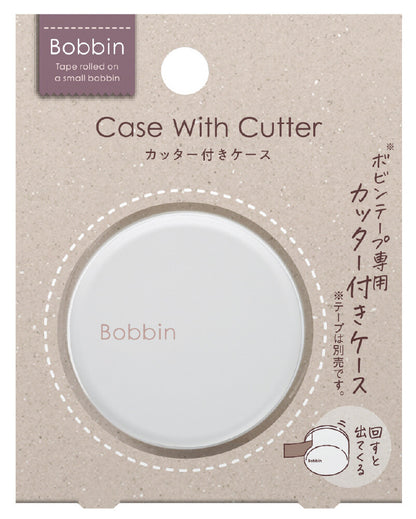 Bobbin case with cutter packaging on a beige background
