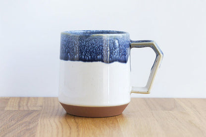 Japanese Ceramic mug with blue and white design on a wooden surface. Made in Japan