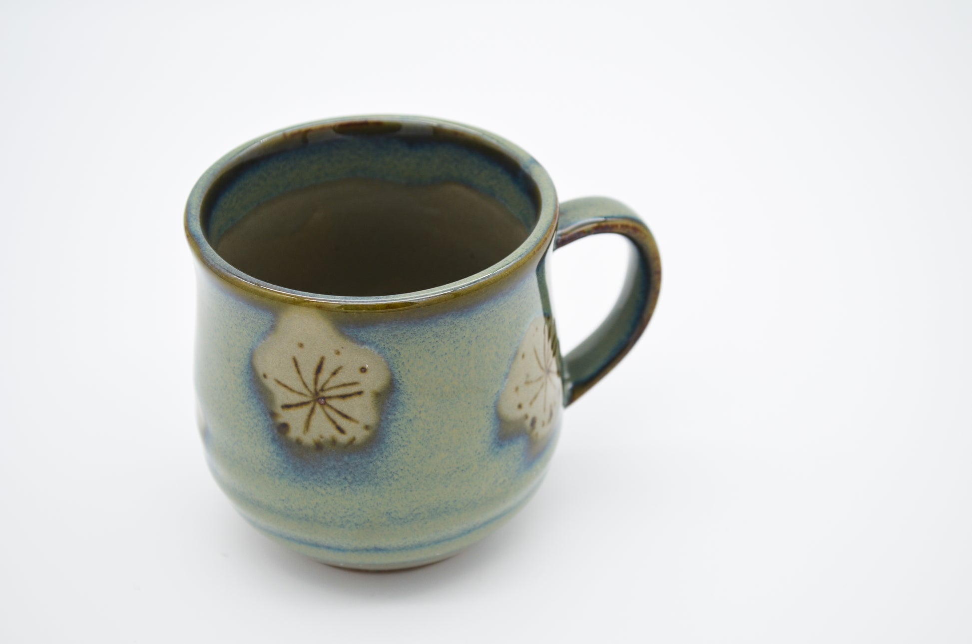 Ceramic mug with decorative elements on a white background