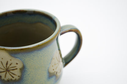 Ceramic mug with floral designs on a white background