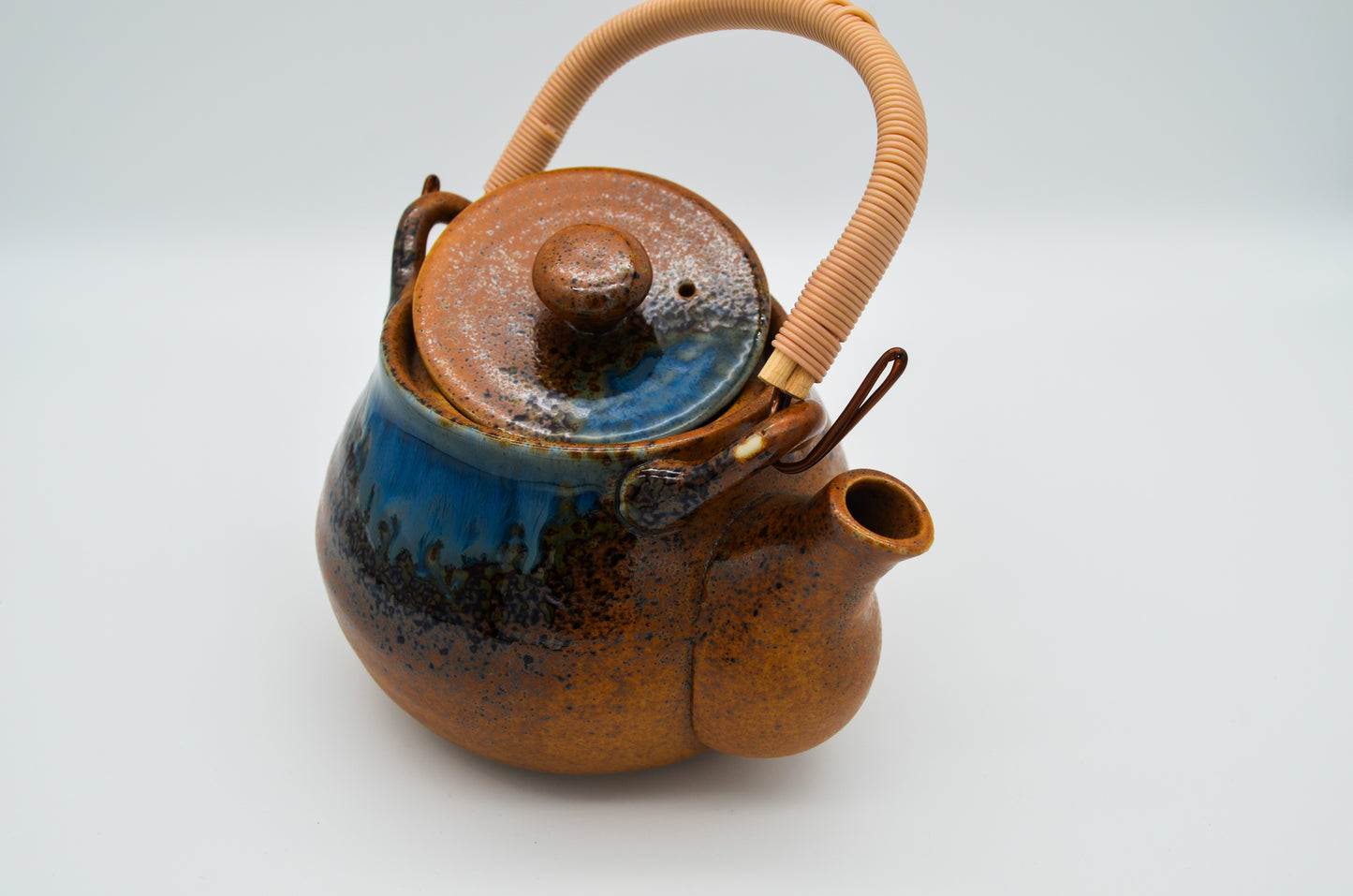 Ceramic teapot with a blue interior on a white background