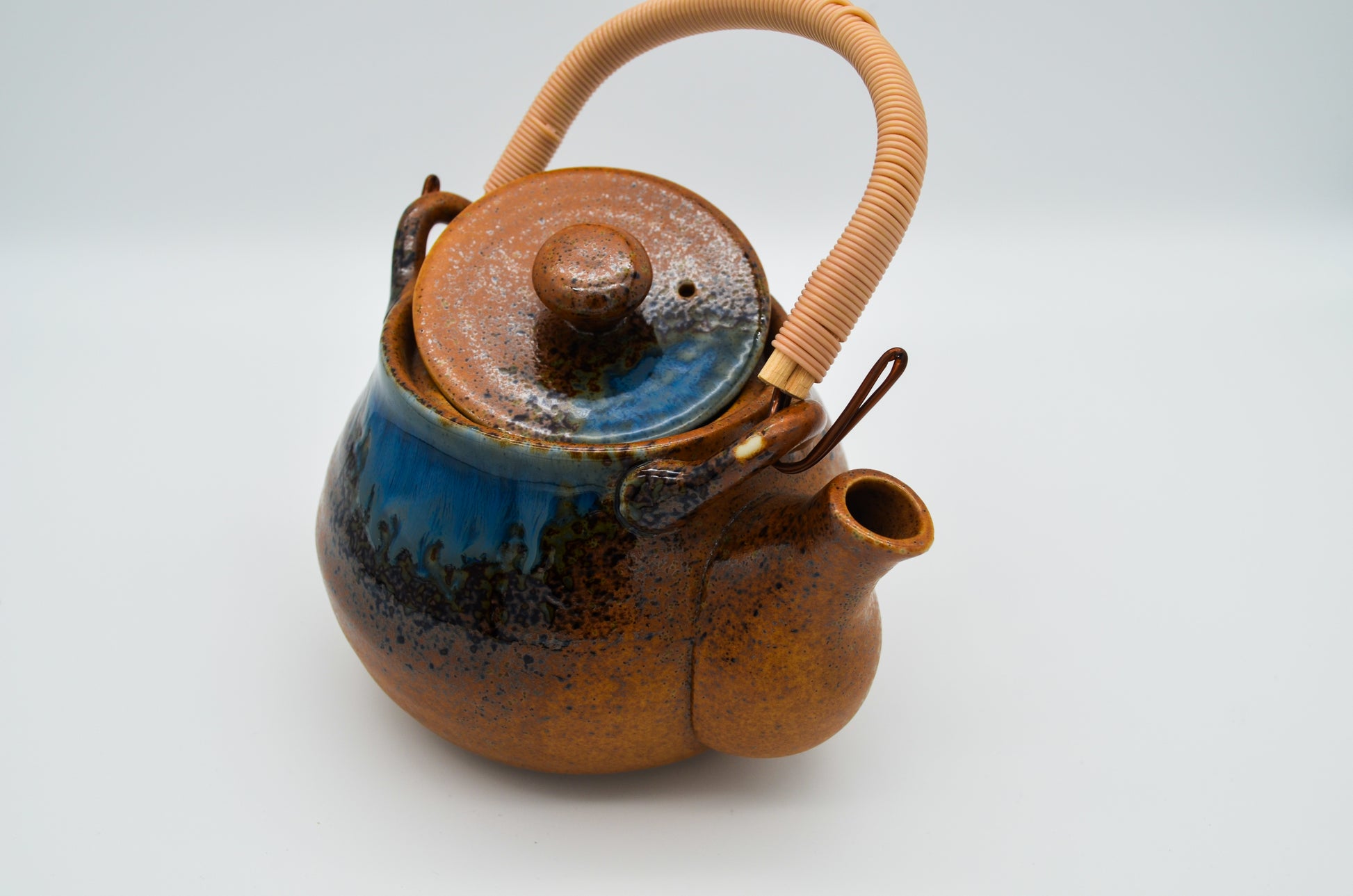 Ceramic teapot with a blue interior on a white background