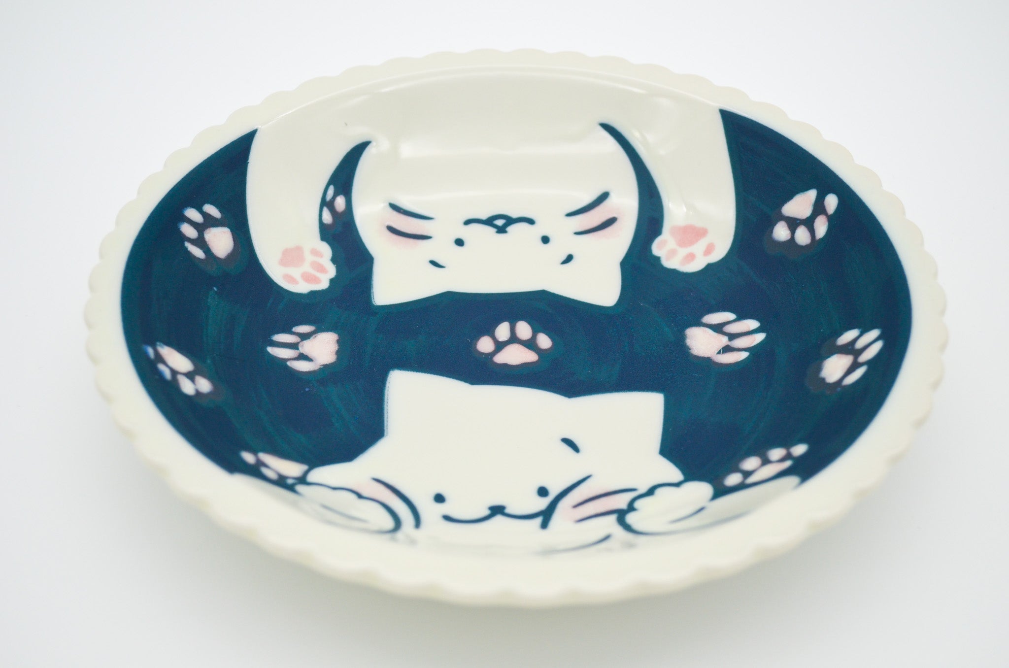 Ceramic bowl with cat design on a white background