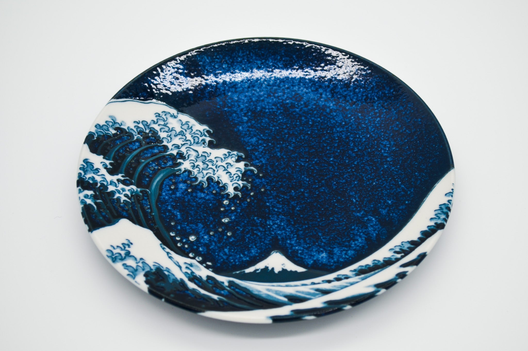 Ceramic plate with wave design on a white background