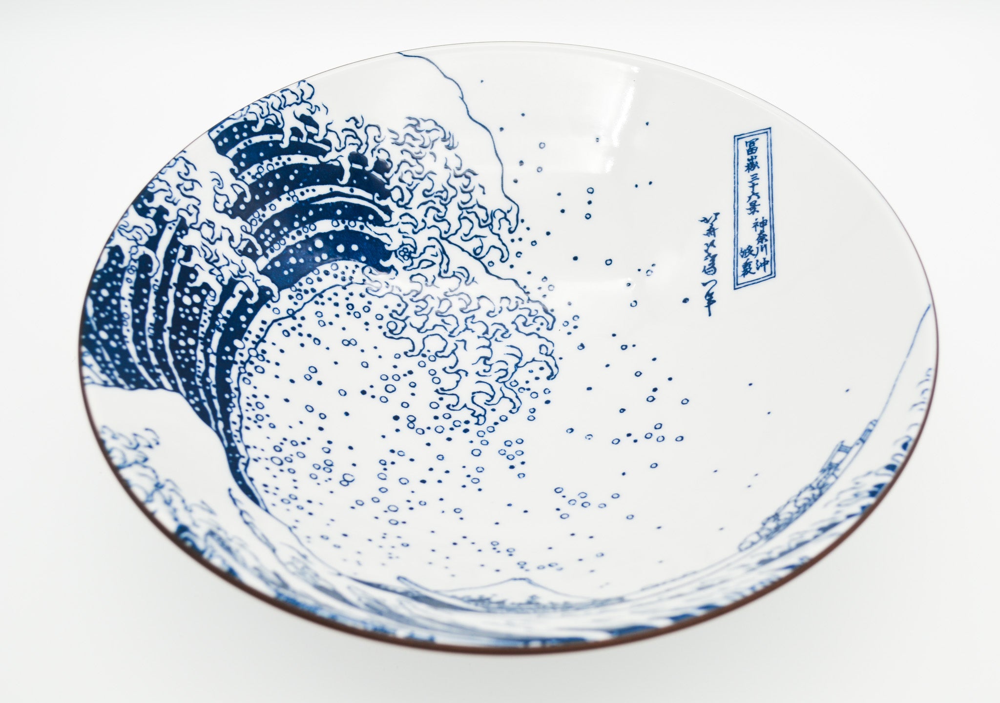 Ceramic plate with blue wave design on a white background