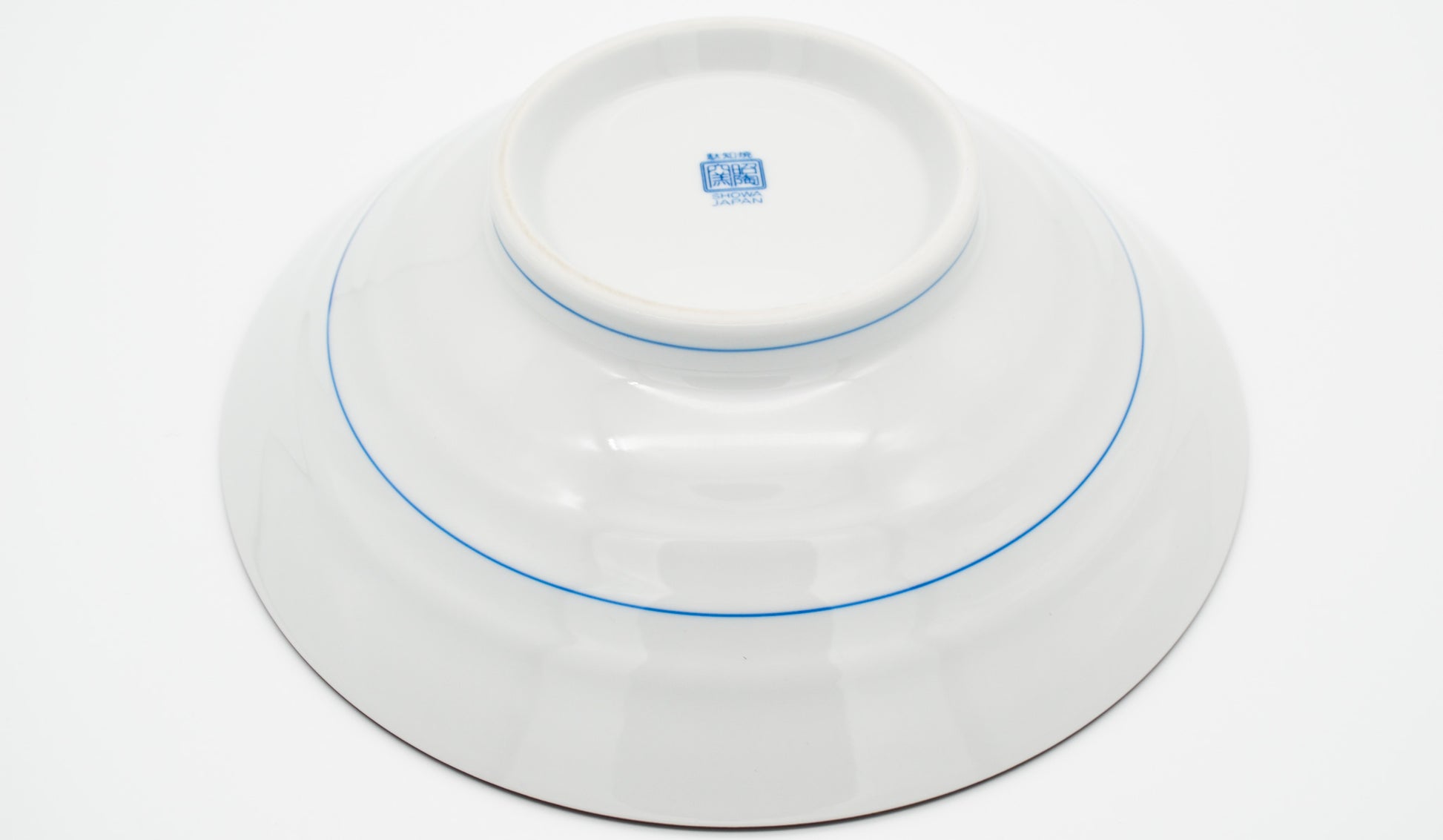 White ceramic dish with blue rim and logo on a white background