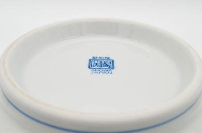 White ceramic plate with blue 'Showa' logo on a white background