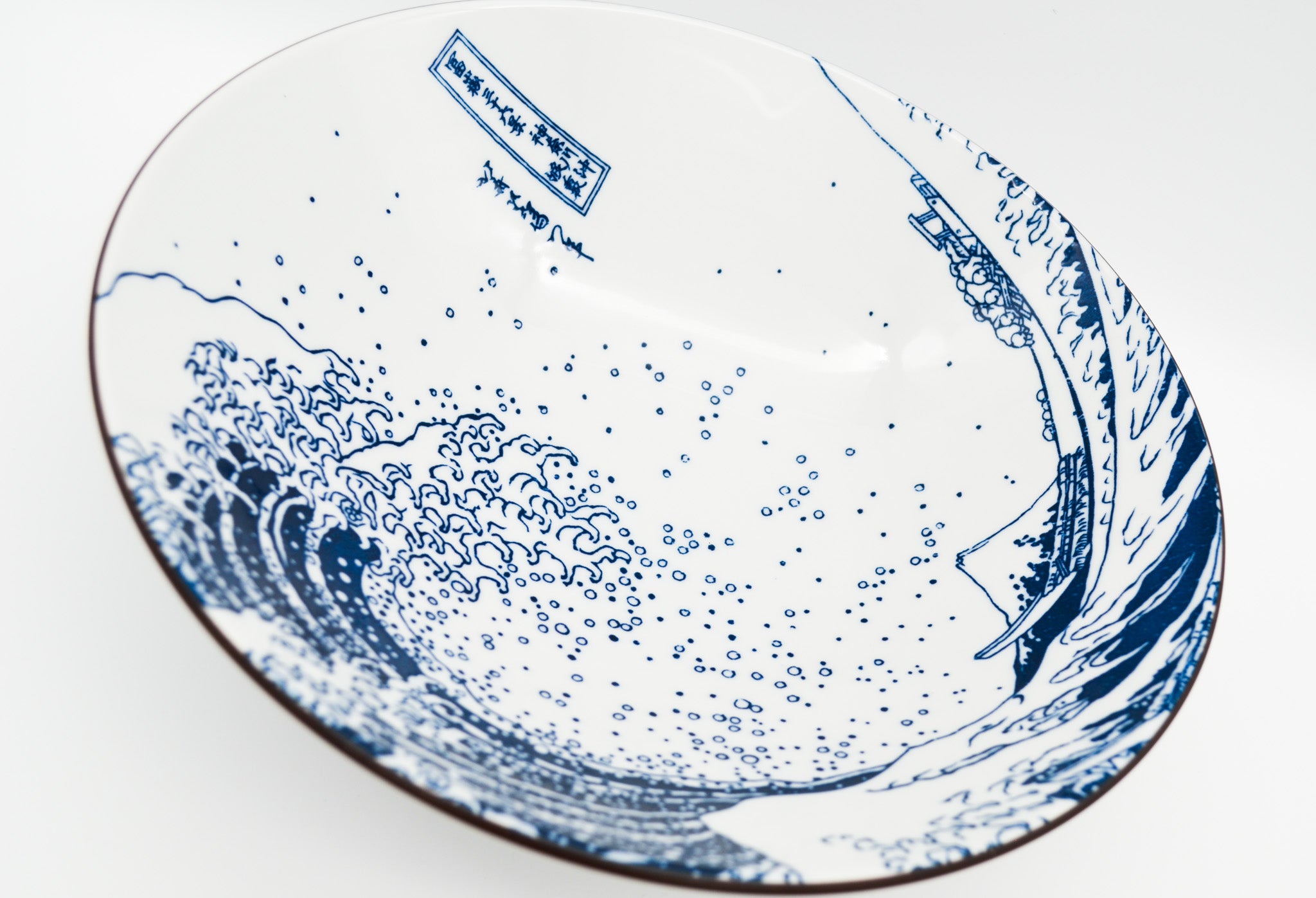 Ceramic plate with blue wave design on a white background